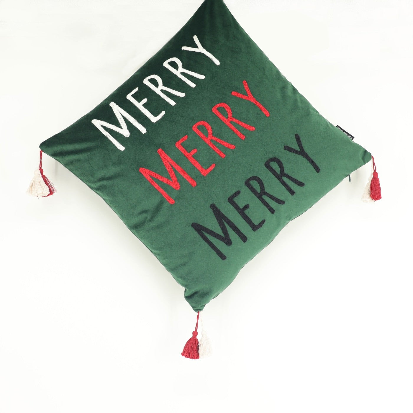 Green pillow with 'MERRY' text in white, red, and black on a white background
