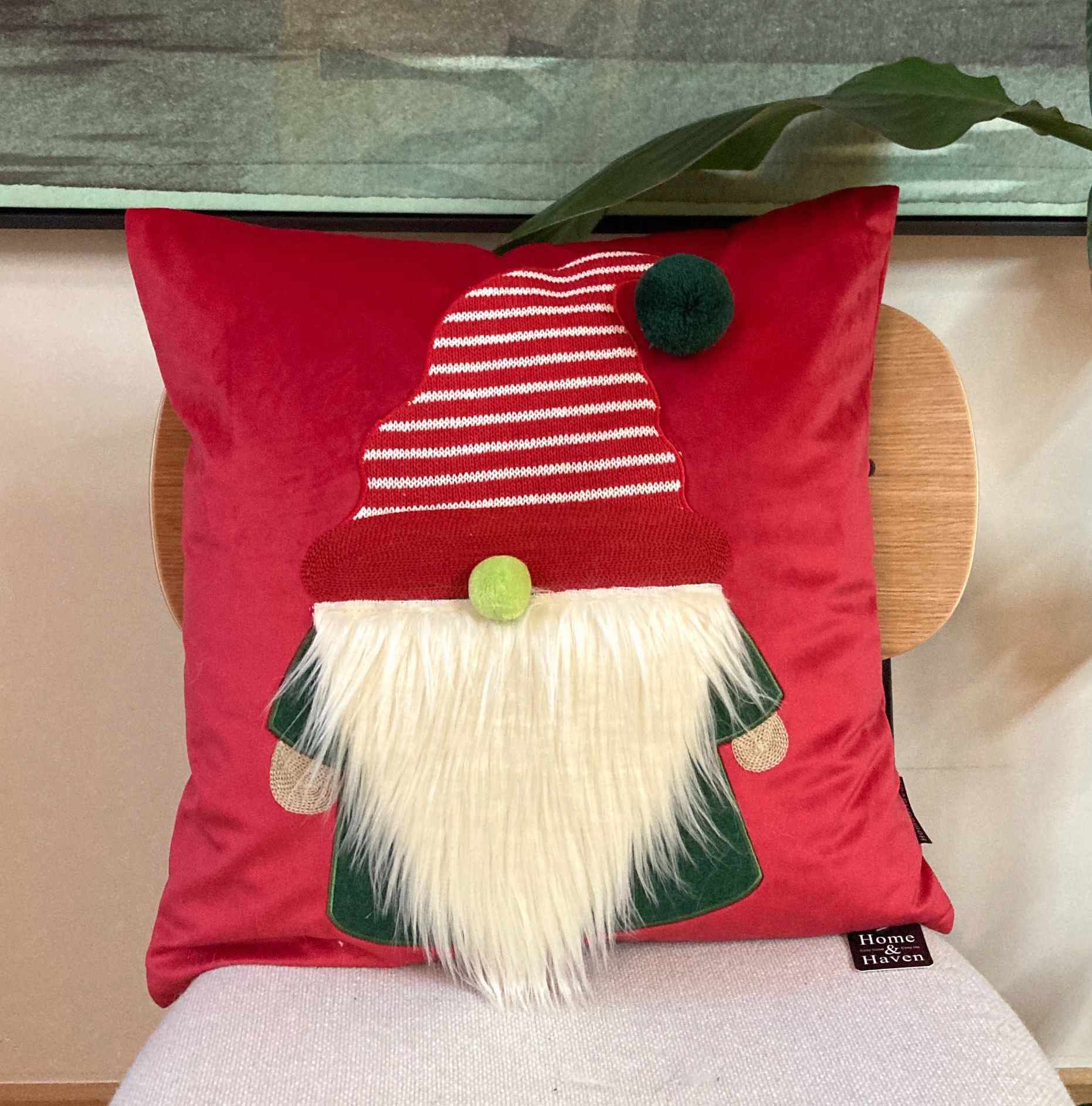 Red Festive cushion with a gnome design on a chair