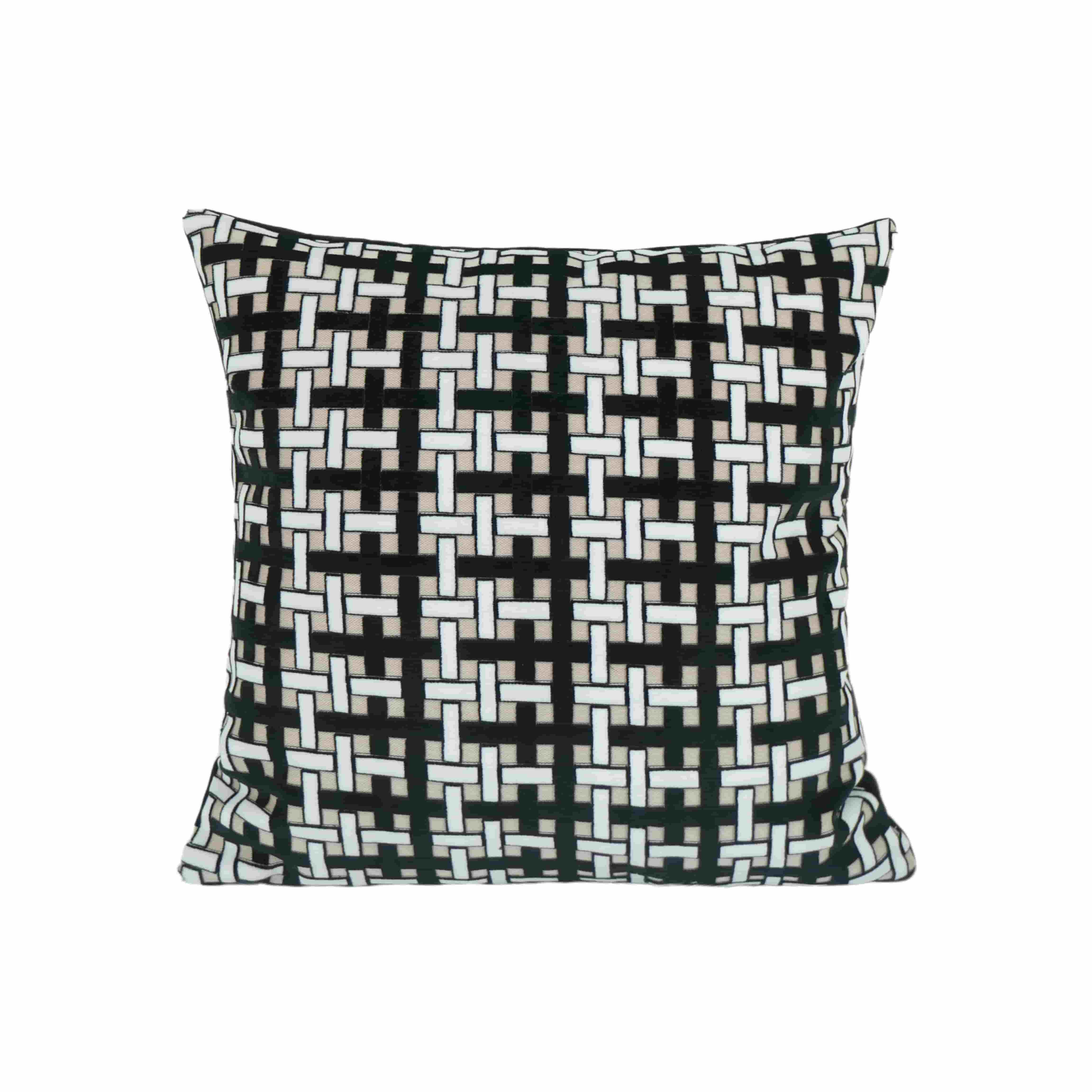 Flat lay of a modern geometric cushion cover featuring an interlocking black and white woven pattern on a clean background.