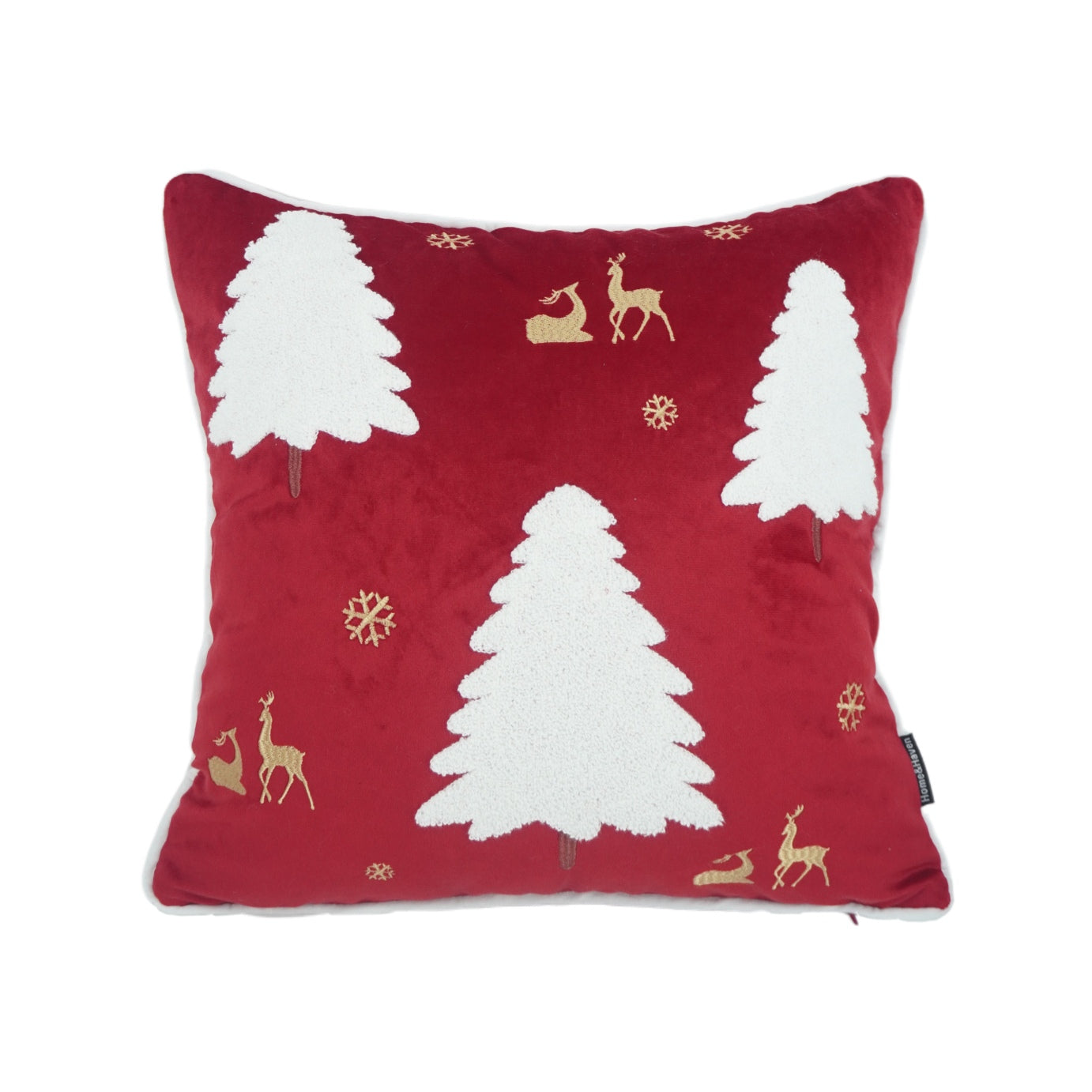 Red pillow with white trees and gold deer on a white background
