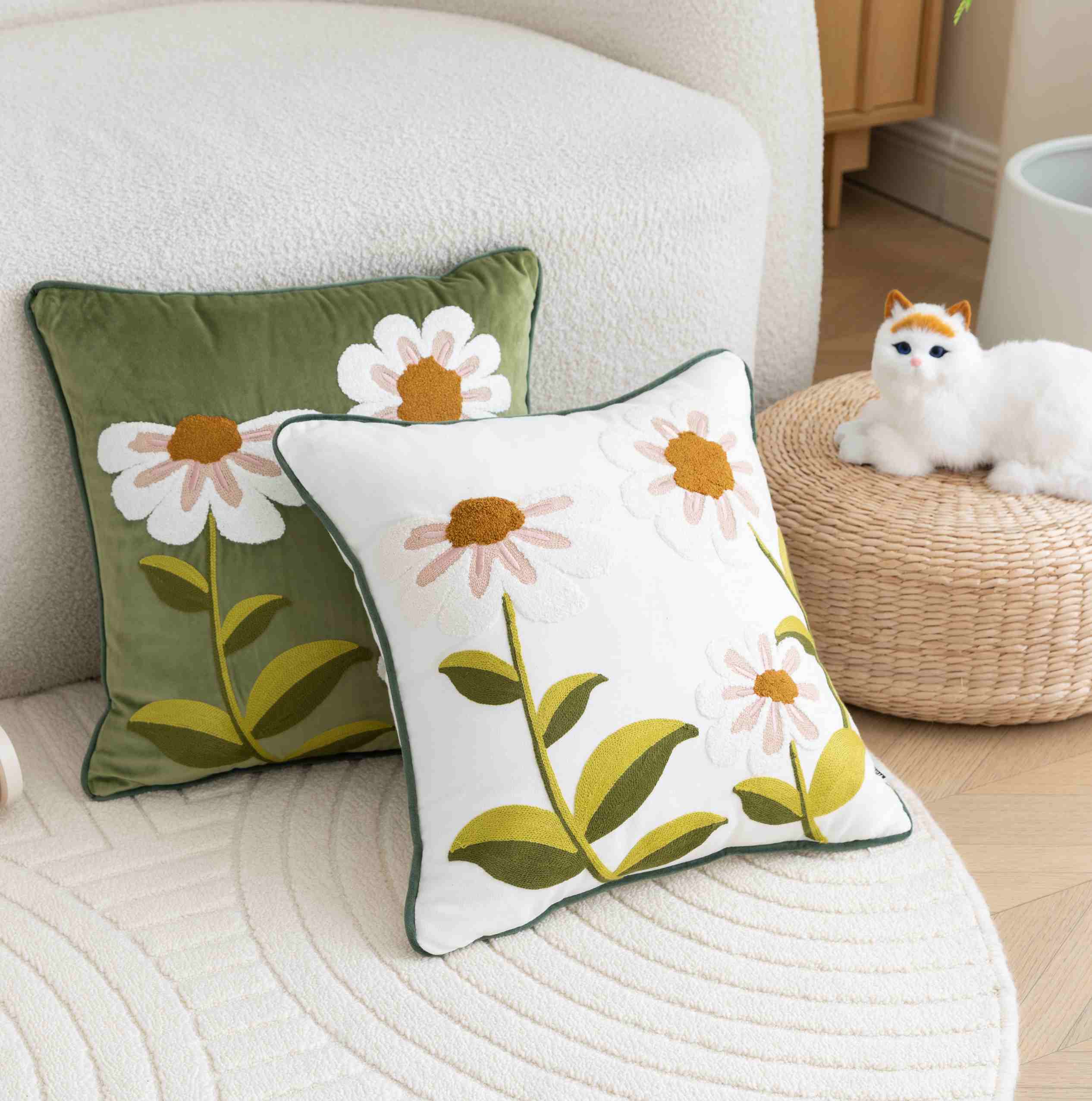 Floral-patterned cushions on a sofa with a cat toy in the background