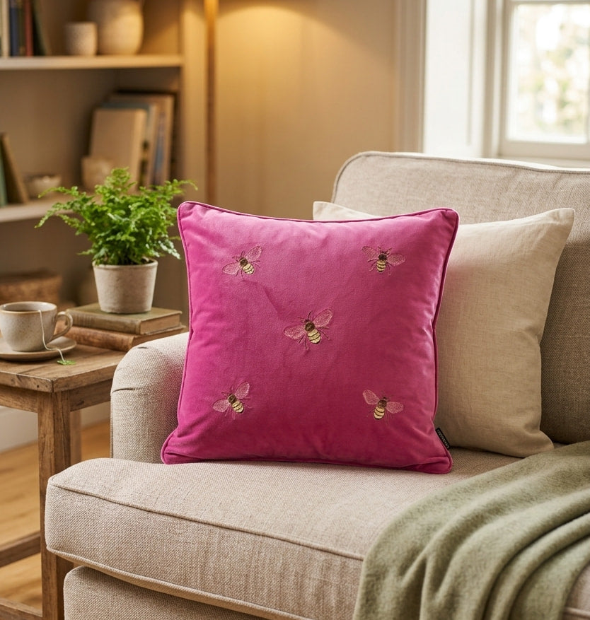 Pink velvet cushion cover with embroidered bee design on sofa
