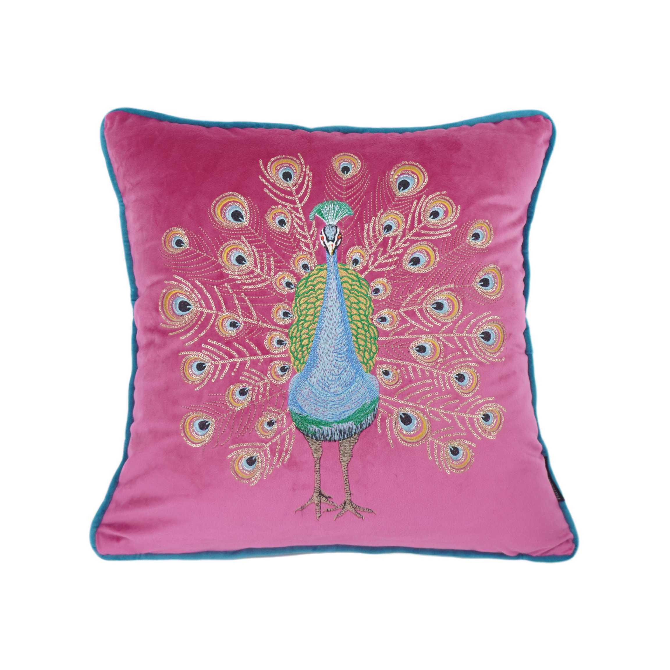 Pink pillow with peacock design on a white background