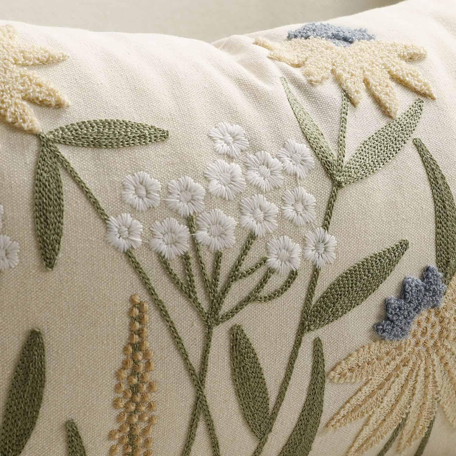 Close-up of wildflower embroidery on a cream lumbar pillow cover 2